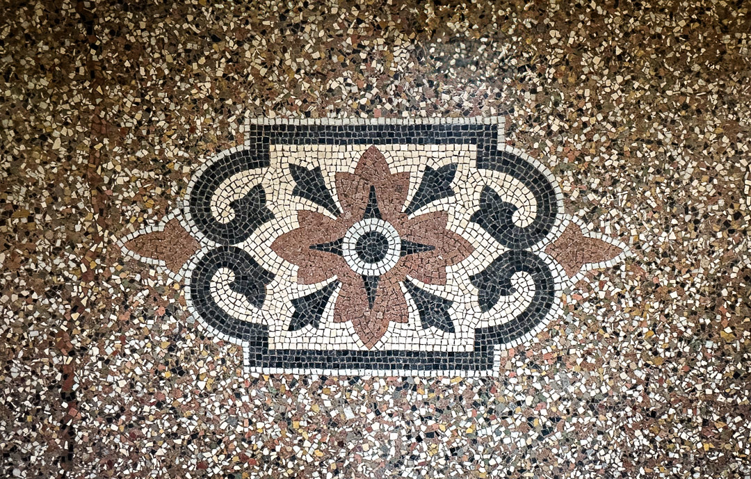 Décor en mosaïque de ciment incrusté dans un sol en terrazzo d'une demeure bourgeoise à La Roche-Vineuse.