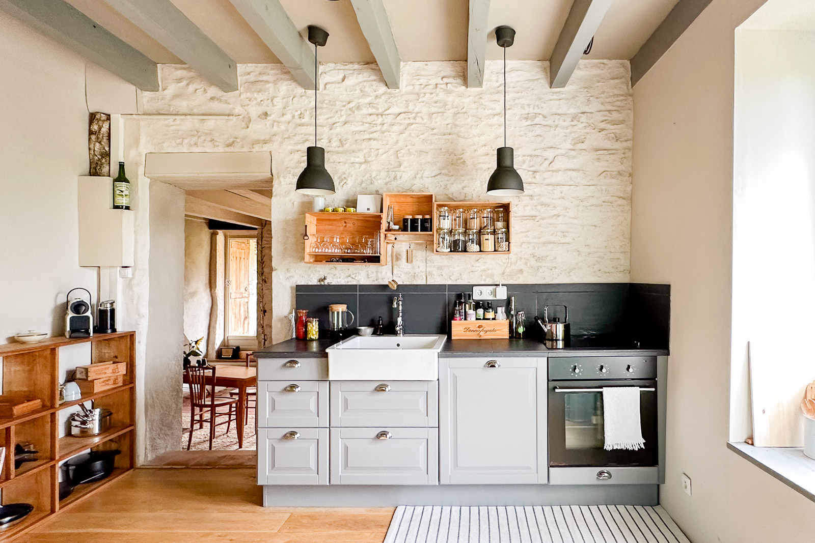 Cuisine rénovée avec poutres apparentes et murs anciens dans une maison de caractère proche de Cluny